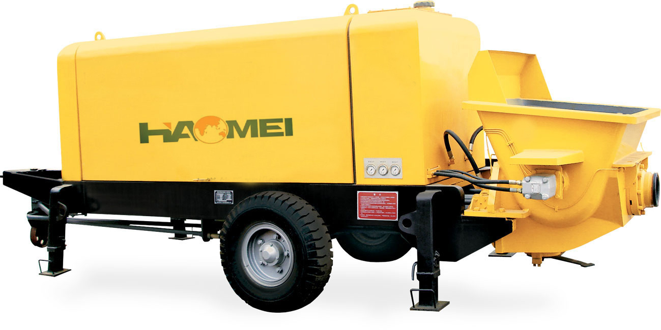 Trailer concrete pump for high pressure concrete delivery